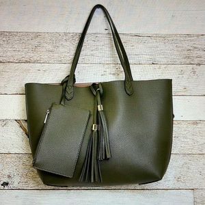 Tote is a deep olive green! It comes with 1 added piece & tassel ornamentation.